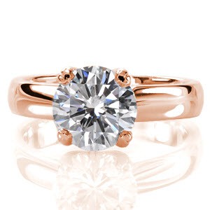 Breathtaking with classic simplicity the Jill Dianne design features a 1.50 carat round brilliant cut diamond. This solitaire is set with reverse V-prongs above a wide, high polished band. The luster of the band compliments the vivacious fire and brilliance of the center stone. 
