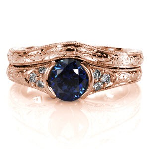 The Seville Engraved Matching Band is hand crafted in 14k white gold and designed to wear next to the Seville engagement ring. The wedding band slightly contours to follow the shape of the engagement ring for a close fit. Details of hand engraved scrolls, filigree curls and milgrain create this heirloom.