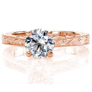 Tara, a classic solitaire, displays a timeless 0.75 carat round brilliant center diamond. The addition of the tantalizing hand engraved patterns are meticulously carved one line at a time. The graceful hand formed filigree curls adds a vintage charm to the side of the band. 