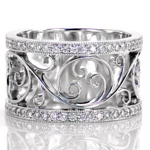 St. Louis wide band wedding ring with filigree pattern between diamond bands.