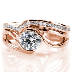 The Motion Channel Band gracefully contours around the clean lines of the engagement ring. It is embellished with 0.12 carats of channel set diamonds, that elegantly capture the light. The band and engagement ring as a set are perfect compliments to one another.  
