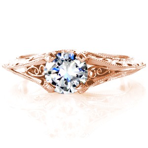 Rose gold solitaire engagement ring in St. Louis is a gorgeous antique solitaire. The split shank knife-edge band is detailed with hand engraving and hand formed filigree curls.