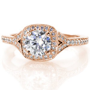 Rose gold engagement ring in Rochester with cushion shaped halo, round center diamond and split band.