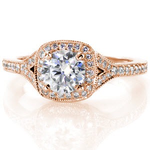 Rose gold engagement ring in Rochester with cushion shaped halo, round center diamond and split band.