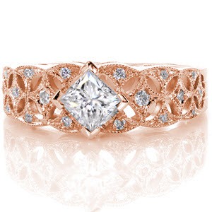 The intricate pierced marquise-shaped pattern adds detail and openness to the band. Micro pavé and milgrain fill the remaining edges for a touch of glamor. The 0.50 carat princess cut is kite-set to give this square shaped center a dramatically larger appearance. 
