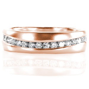 Function and design join in the Virage design beautifully. A single row of round cut diamonds totaling 0.67 carats gently waves around the whole band. The diamonds are channel set by hand for maximum security and sparkle. A satin finished 14k white gold band compliments this innovative design.