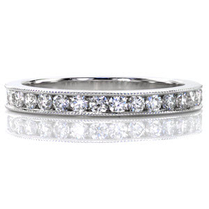 The Vita design is a classic channel set band with just the right amount of detailing. Crafted in 14k white gold, the channel set band has a total 0.39 carats of round cut diamonds. Both of the channel edges are finely detailed with hand applied milgrain texture.