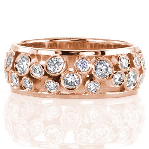 Rose gold wedding band in Charlotte with round cut diamonds bezel set.