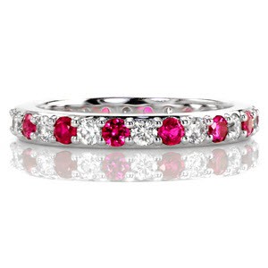 The Ruby Eterno displays a rich design of alternating bright white diamonds and natural red rubies. Set within unique shared prongs, the alternating round gemstones create an endless pattern. Crafted in 14k white gold, the band is finished with high polished sides.