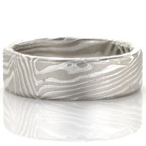 This striking wedding band is created from a sterling silver and 14k palladium Mokume Gane. The seamless pattern resembles wood grain and is created by hand in our Minneapolis Production studio. Once the design is complete the ring in put into a silver etching solution which creates dimension on the piece.