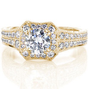 Yellow gold halo engagement ring in Sacramento. This unique halo engagement ring features a custom halo shape, with a wide band. The top of the band and halo are set with micro pave diamonds. The sides are detailed with hand crafted filigree curls and hand engraved patterns for a vintage appeal.