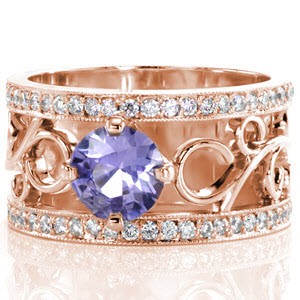 The radiant color of the 1.00 carat purple sapphire is mesmerizing sight in this unique signature wide band. Large filigree curls add movement to the colorful round center stone. Rows of micro pavé form the outside edge of the band and are accented with milgrain texture.