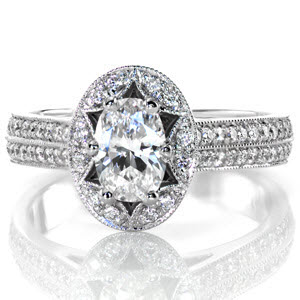A scalloped halo design, embellished with micro pavé diamonds, accentuates the six prong .75 carat oval center stone. The diamonds continue and form a pierced diamond and crescent shape that is framed with milgrain detail. The diamonds continue on the band forming two rows of incredible brilliance. 
