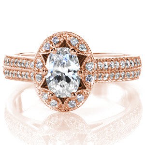 Custom rose gold engagement ring in Des Moines with a uniquely shaped antique inspired halo surround an oval cut diamond