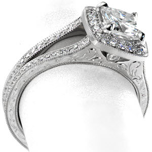 Beautiful split shank engagement ring in Miami, FL. This lovely cushion halo design features micro pave diamond in the halo and on the band. The sides of the band are elegantly adorned with hand engraving and surprise diamonds.