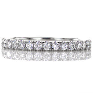 Our Jolie band is a classically beautiful statement with a single row of glimmering diamonds. The delicate band has .47 carats of round brilliant diamonds. Each stone is perfectly set in a U-cut shared prong setting created by hand by our artisan jewelers. 