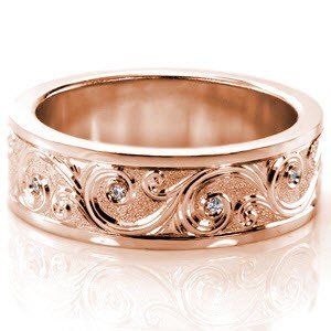 Bridgeport custom wide band ring with high polished rails bordering a central scroll style hand engraving pattern with bezel set diamonds and a sandblasted background.
