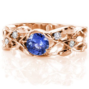 Rose gold engagement ring in New Orleans with nature inspired patterns and blue sapphire center stone.