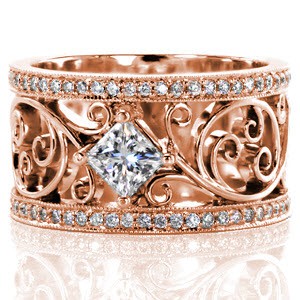 Custom engagement ring with a unique scroll patterned wide band border by diamond rails and a princess cut center stone in Riverside.