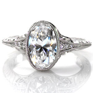 Unique Engagement Rings in Tampa with elegant hand formed filigree curls and beautiful hand engraving. This stunning antique engagement ring style is shown with a bezel set oval center diamond on a knife edge band.