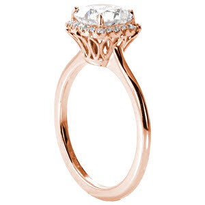 Rose gold custom engagement ring in Toronto with a cushion cut center diamond surrounded by a diamond halo. 