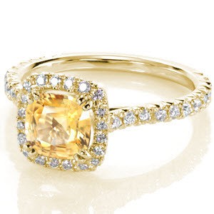 Yellow gold and sapphire halo engagement ring in Portland. Beautiful micro pave diamond halo and band set around a yellow cushion cut sapphire.