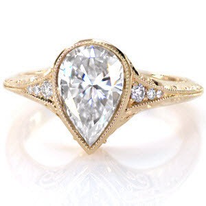 Antique engagement ring in Fargo with pear shape center stone, filigree and hand engraving. 