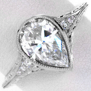 Antique engagement ring in Fresno with hand engraving, milgrain and pear shape center stone.