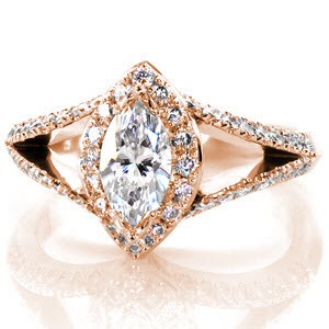 Custom rose gold split shank engagement ring in Providence. This marquise cut diamond engagement ring features a micro pave diamond halo and split shank band. The basket under the halo features hand formed filigree in delicate curls.