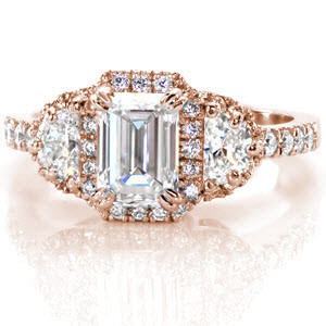 Rose gold engagement ring in St. Louis with emerald cut center stone and half moon side stones.
