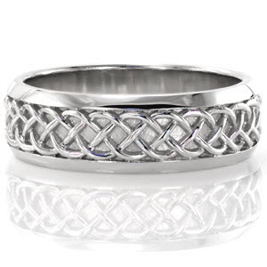 Intricately woven strands of gold create a signature design for the Celtic Wedding Band. Hand crafted in 14k white gold, this wide wedding ring features a traditional Celtic design. The two beveled high polish edges provide comfort and bring focus to the center pattern.