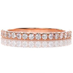 Our 14k rose gold Jolie band has an astounding warmness that balances the cool white tone of the glimmering diamonds. Each stone is hand set in a scalloped shared prong setting for optimal sparkle. The high polished rose gold finishes the ring exquisitely. 