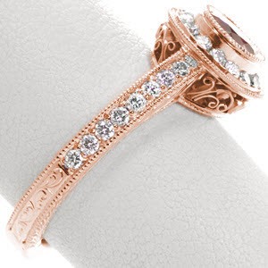 Filigree engagement rings in Indianapolis with a regal red ruby center stone. This stunning vintage halo engagement ring features a channel set halo around the bezel set center gem. The made features a mix of micro pave and milgrain while the basket underneath is filled with filigree.