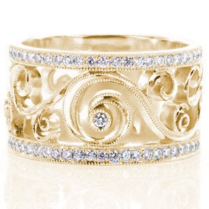 Madison custom wide band ring with bead set diamond rails surrounding a bezel set diamond scroll pattern.