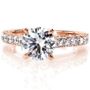 This magnificent ring is design to enthrall with its 1.50 carat round brilliant center diamond. The center stone is elevated above the queenly band in a cathedral setting and the design is accented with micro pavé not only on all sides of the band, but on the prongs of the center diamond as well.