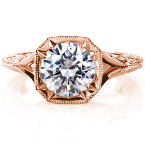 Baltimore engagement ring in rose gold with round center stone and engraved band.