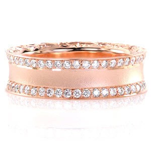 This glamorous concave diamond band is featured in a lovely 14k rose gold metal. Curved edges are decorated with hand engraved scroll-work for a picturesque view. Two rows of bead set diamonds line the top of the ring for brilliance. The sandblasted finish adds a chic texture along the center of the design. 