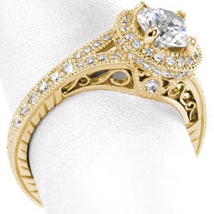 Antique engagement ring with diamond halo, round center stone and filigree in Raleigh.