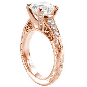 Custom engagement ring with a round diamond center held by four diamond set prongs with a band including bead set diamonds, hand engraving, milgrain and filigree curls in St Louis.