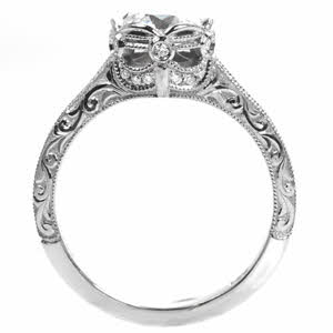 Custom engagement ring in Orlando with relief scroll engraving and bezel set center stone.