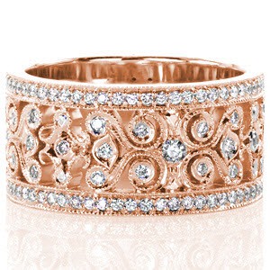 Unique wedding ring in Charleston. This wide wedding band features a vintage style filigree pattern that is edged with milgrain and set with small brilliant diamonds. This rose gold wedding band has micro pave diamond rails highlighting the intricate custom pattern in the middle of the design.