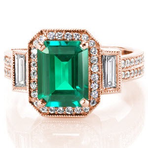 Linear facets of the emerald cut is mimicked in the straight rectangular baguettes that flank each side of the vivid emerald. Brilliantly faceted micro pavé diamonds outline the green gem adding a prism of colors when light strikes the stones. Similar size round diamonds from two rows along the band of the ring. 