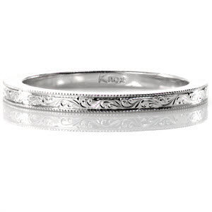The Scroll Engraved Band is an elegant heirloom wedding band crafted in 14k white gold. The hand engraved pattern of scrolls continue throughout the entire band for a continuous look. The hand applied milgrain finishes the ring edges to complete the vintage appeal.