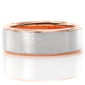 The modern and timeless look of this band offers clean lines and contrasting warm and cool tones. Fabricated in 14k rose gold and platinum, this design features soft high polish edges along with a satin finish center. This two tone look adds a unique quality to this classic design.
