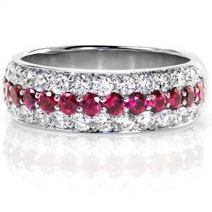 Design 2769 is paved with long rows of diamonds and gemstones. The pavé setting features two rows of stunning round brilliants with a single row of vivid red rubies running between. Small beads of metal securing the stones shine from a high polish giving this design a seamless look.  