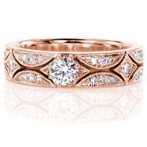 A 0.30 carat round brilliant cut diamond is elegantly displayed in our vintage inspired Polaris design. The unique pattern alternates between crescent and diamond shapes. Each element is embellished with micro pavé diamonds that are framed with milgrain detail for additional glamour. 