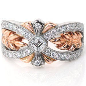 This breathtaking wide band is hand crafted in 14k white and rose gold. The flowing white bands of micro pavé lead the eye toward the asscher cut diamond center. Sprigs of high polished rose gold leaves fill the wide pockets in a warm contrast to the dazzling sparkle of the white diamonds. 