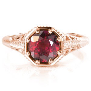 The vivid 1.50 ct. red ruby is showcased in a unique octagonal setting and is held in place with eight bead set prongs for security and detail. Pierced patterns are accented in milgrain texture and a smooth high polish for a striking contrast. The hand engraved wheat pattern adds to the antique feel or this design.  