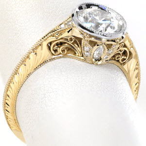 Antique bezel set diamond engagement rings in Omaha feature intricate vintage inspired details. Gorgeous two-tone engagement ring features a platinum center setting on a yellow gold ring. The knife edge band, hand engraving, and hand formed filigree curls really take this diamond ring to the next level!
