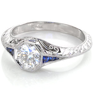 Filigree engagement ring in Madison with blue sapphires, hand engraving and round brilliant center stone.